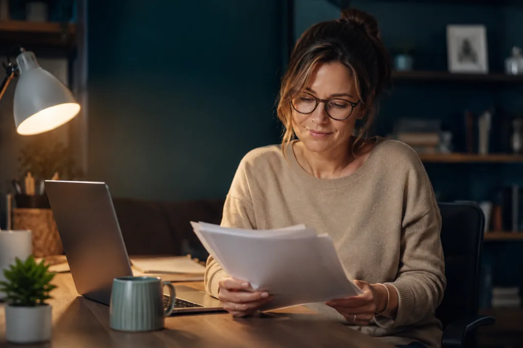 Teacher reviewing side income options for teachers at a home desk